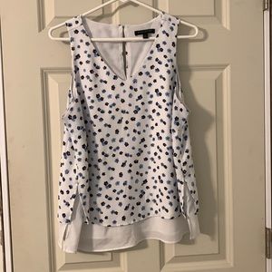 White and blue floral sleeveless Banana Republic blouse.
